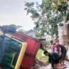 Truk bermuatan pakan ternak terguling di Jalan Gamprit, Sukakarya, Bekasi.