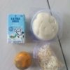 Menu Makan Bergizi Gratis (MBG) berupa roti, susu, keripik tempe, dan jeruk yang dibagikan kepada siswa SDN Karangpatri 04 Pebayuran, Kabupaten Bekasi, Senin (23/2/2026).